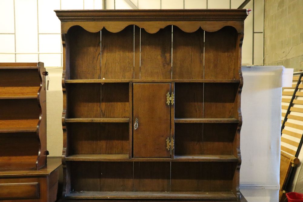 An 18th century oak low dresser with later boarded plate rack, width 128cm depth 46cm height 216cm